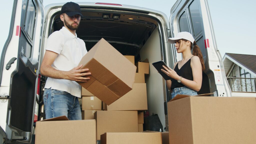 movers loading a truck in a residential area showing movers cost huntsville al